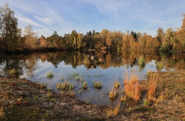 Autumn landscape with lake reflections.