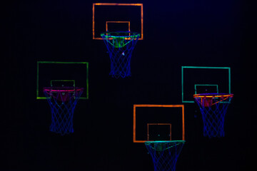 Neon basketball hoops in dark setting