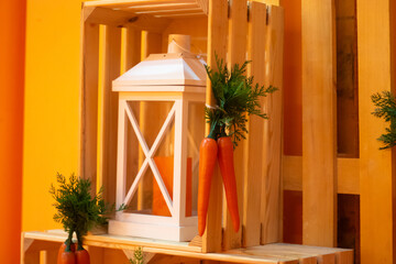 Decorative wooden lantern with greenery and carrots