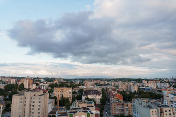 Fototapeta premium Cityscape View with Apartment Buildings and Dramatic Cloudy Sky at Dusk, Ukraine Urban Landscape Photography