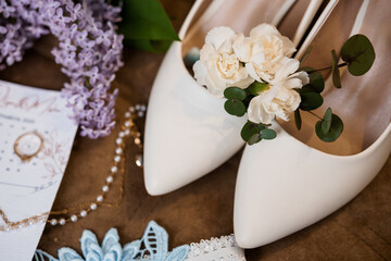 Romantic Wedding Details: Ivory Shoes, Lilac Blooms, Pearl Necklace and Ring, Delicate Card, Soft Lighting and Feminine Style