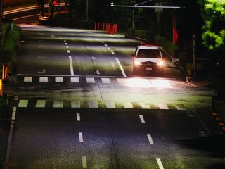 Tokyo, Japan - August 10, 2025: A patrol car on wet street at night © Khun Ta
