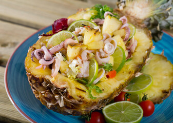 Stuffed pineapple with squid and lime. Seasoned by sauce of pineapple juice, lemon, olive oil, lime and chili pepper