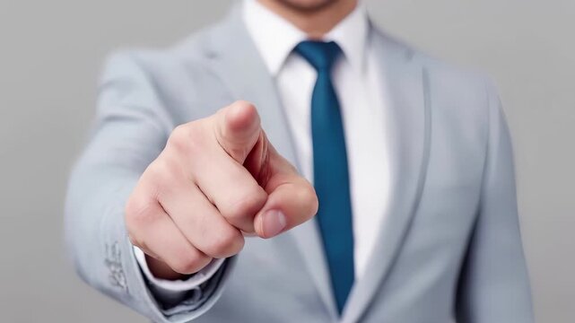 Professional businessman points finger in corporate gesture of selection, direction and leadership. Executive decision making, target focus and business communication in formal office environment.