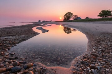 Serene sunrise over a tranquil beach.  Clear water pools reflect a vibrant sunrise sky.  Pebbly beach foreground