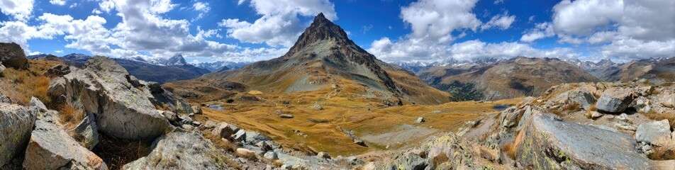 Panoramic alpine vista, rugged peaks, and a vibrant, golden valley under a dramatic sky