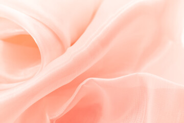 Obraz premium Close-up of soft flowing pink fabric with gentle folds and translucent texture, ideal for backgrounds, fashion branding, wellness visuals, romantic themes, and elegant minimalist design compositions