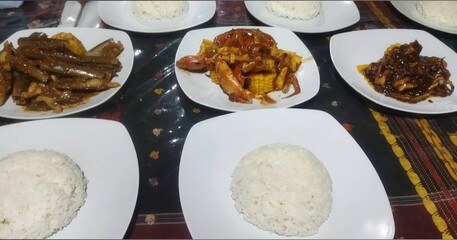 Steamed white rice served with a variety of flavorful side dishes for a complete and satisfying meal.