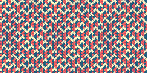 Geometric knit texture. Seamless pattern in coral, cream  navy.  Ideal for textile designs, website backgrounds, or crafting projects.