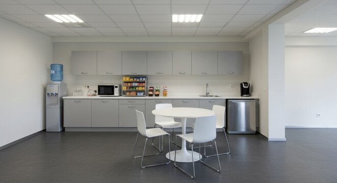 Modern office break room with minimalist design and ample counter space