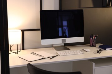 Desk with computer, stationery and glasses at home office. Interior design