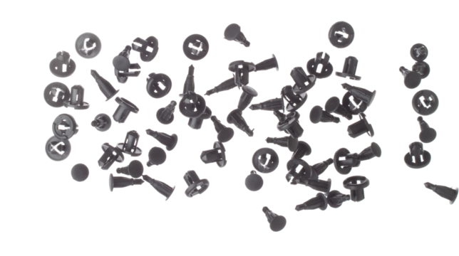 Fastener plastic clip fly explosion, black automobile fastener clip float explode, abstract cloud fly. automobile plastic fastener clip splash throwing in Air. White background Isolated