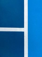 Pickleball Court Closeup View. Vibrant colored racquet sport court closeup, overhead view. Serving and out of bounds lines create a grid pattern.