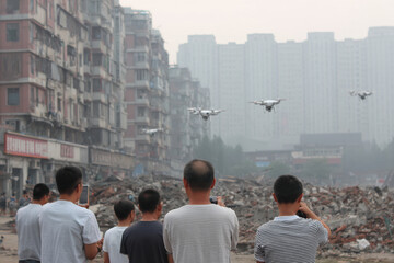 cloud of drones meticulously creates d map of devastated city while people observe technology at work