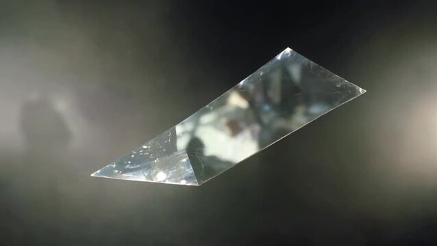 Crystal prism with light refraction: A stunning prism, meticulously cut and polished, stands alone to refract rays of light. A visual feast showcasing the intricate dance of light and color.