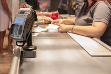 Payment machine in supermarket. Clients pay  with credit card or contactless smartphone payment. Business concept