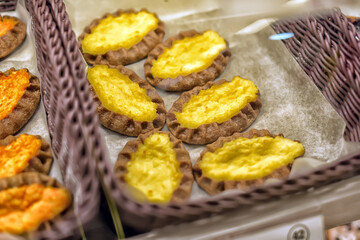 Traditional Finnish kalitki with potato filling, laid out in a basket on parchment paper. 