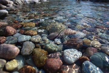 River Rocks Under Clear Water: Close-Up View of Submerged Pebbles