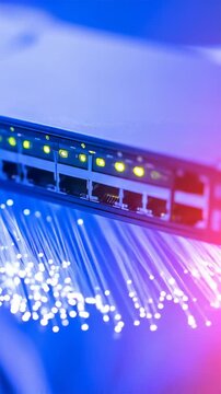 Illuminated Fiber Optics with Glowing Router Ports in Blue and Pink Hues on Dark Background