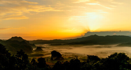 Sunset mountain range beautiful landscape mist foggy sunrise beam. Golden sky Mountain landscape foggy windy mountain. Amazing Landscape cloud sky on sunrise. Countryside gold sunlight heaven scene