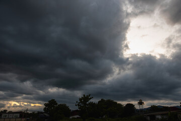 Dark rain cloud dramatic sky summer tropical thunder storm sky and fluffy black darkness cloud...