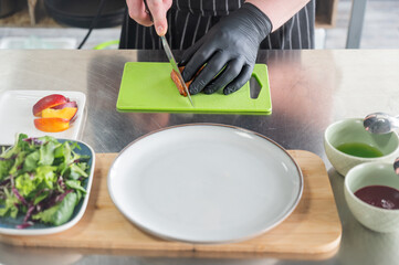 The chef slices the roast duck. 