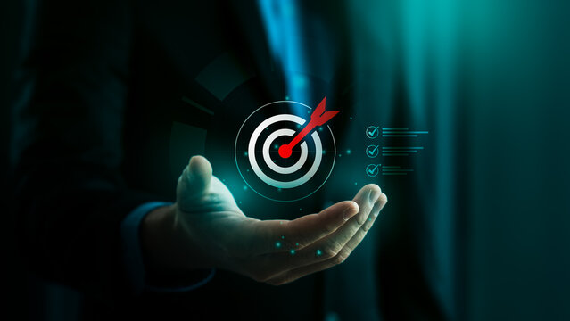 Business goal setting and strategic success concept with businessman holding digital target icon and checklist, symbolizing planning, achievement, focus, and performance tracking for 2026 objectives