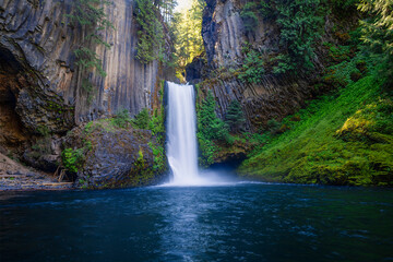 Toketee Falls cascades into deep blue pool.