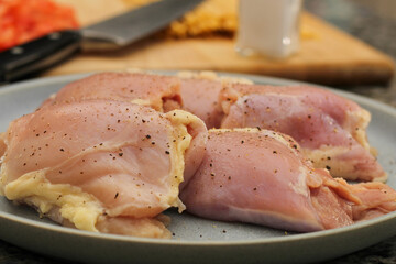 Raw Chicken Thighs on Plate Ready for Cooking