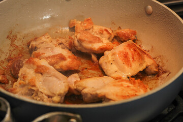 Chicken Thighs Searing in Frying Pan