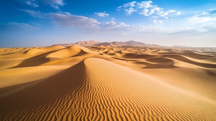 Aerial perspective of a remote desert, tall sand dunes sculpted by the wind, their shadows forming dark, dramatic contrasts on the sunlit sand