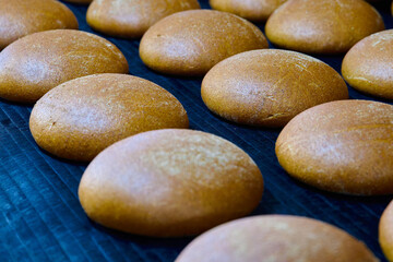 Freshly baked white-rye blend bread cooling at bakery oven outlet with a variety of mixed grain loaves