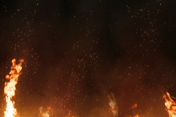 黒い背景に燃え上がる炎の火の粉の背景素材のテクスチャ