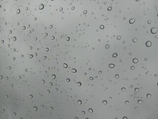 Background of water drops on a window glass in a rainy day
