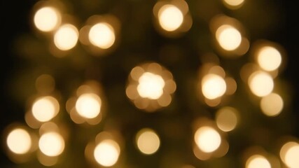 Warm golden bokeh lights against a dark background with a shallow depth of field - Powered by Adobe