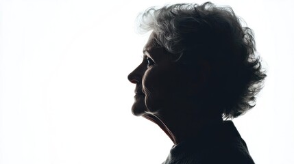A silhouette of an elderly woman against a white background, with a contemplative expression and slightly tousled hair.