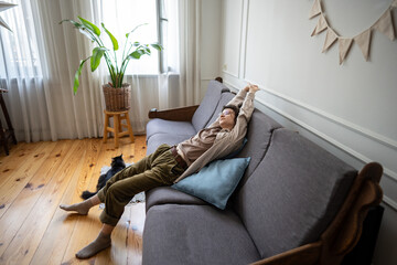 Tired stretching woman lying still on sofa alone, mind disconnected from action trapped in...
