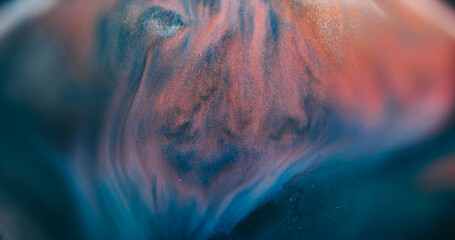 Blur ink spatter. Marble texture. Defocused orange blue color glitter water shiny particles spreading on abstract acrylic background.
