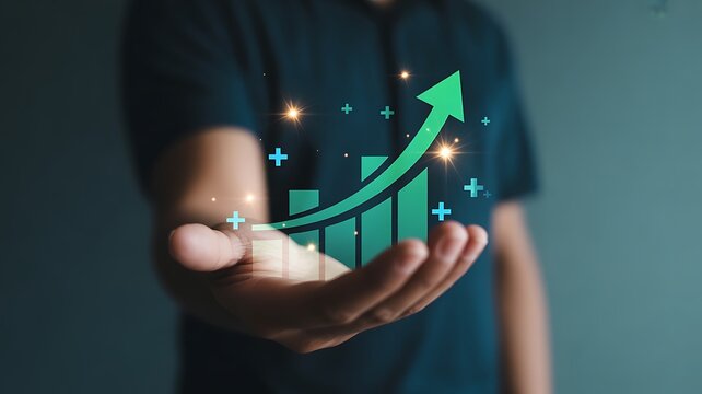 Person holding a green upward trending bar graph with sparkling lights business growth