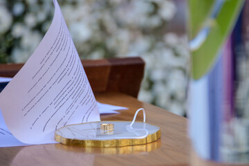 wedding table setting, wedding rings on a decorative plate, ceremony vows and golden rings, a close-up of marriage symbols