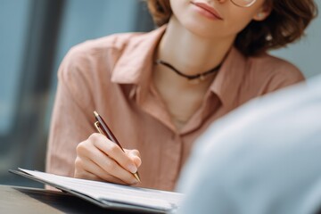 Female therapist provides support and guidance in an office setting psychologist offers healthcare and documentation for mental health consultations