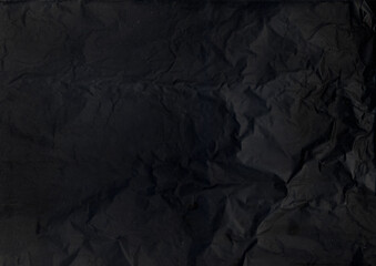 Fototapeta premium Obsolete texture. Black sheet background. Dark weathered uneven paper. Old crumpled rough art gray textile abstract defocused page.