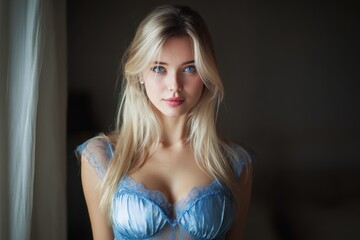Fototapeta premium Gorgeous lanky Russian blonde wearing a blue dress