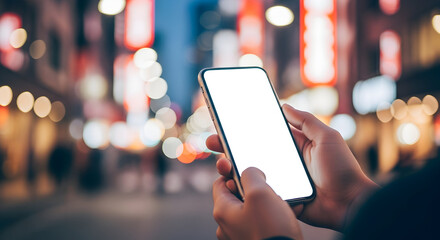 Person using smartphone at night city background blank screen mockup modern technology mobile device app communication connection digital lifestyle urban scene
