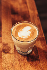 Cortado with Feather Latte Art — Centered on Wood Grain