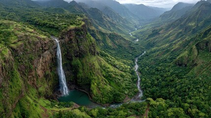 Lush valley with waterfall cascading into emerald pool