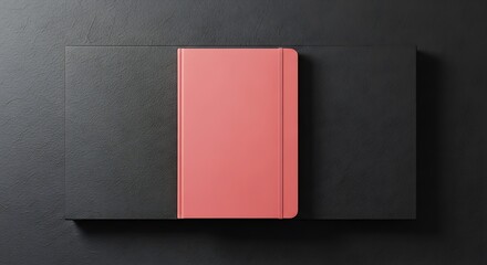 Fototapeta premium A coral pink journal in a dark gift box, a stylish tool to whisk together creative ideas.