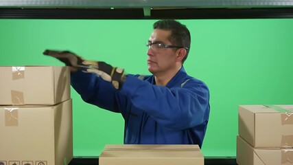 Worker Sorting Cardboard Boxes on Conveyor Belt Against Green Screen - Powered by Adobe