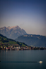 Rural landscape in the Swiss Alps. Lake Lucerne, Switzerland. A view to the lake of Lucerne. Rural landscape. Resort surrounded by swiss Alps mountains on Lake Lucerne, Switzerland.