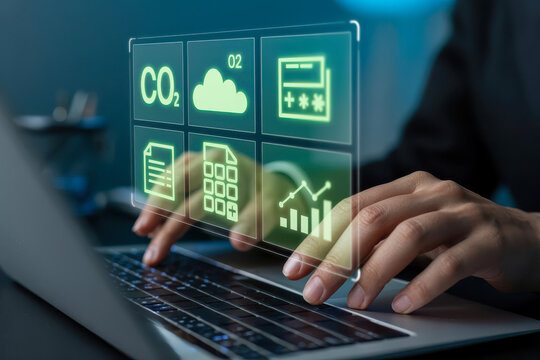 Person using a laptop with a digital interface showing carbon dioxide emissions and environmental data analysis for sustainability strategy